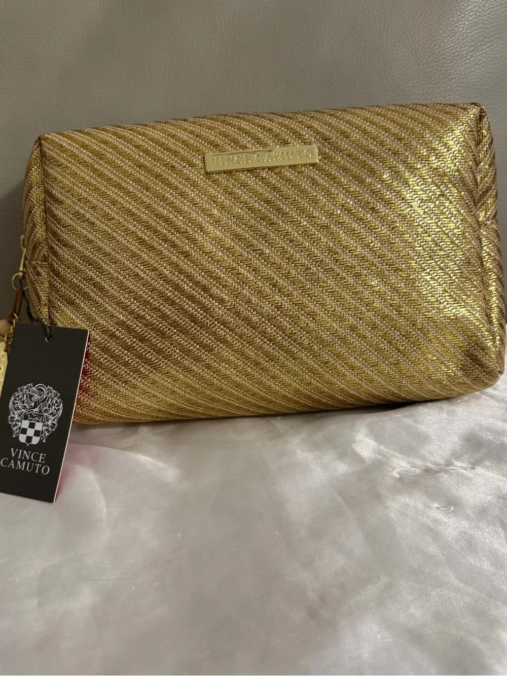 Vince Camuto gold woven canvas metallic cosmetic Bag with starfish Tassel charm.